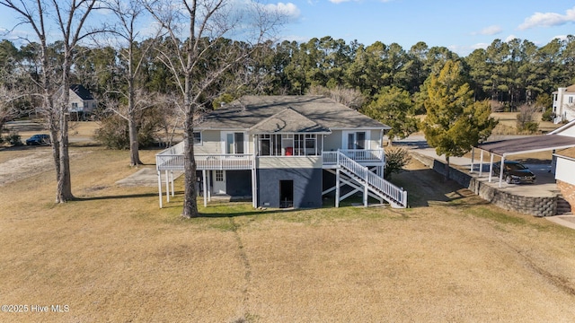 rear view of house featuring a lawn