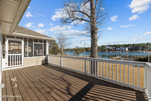 deck featuring a water view and a sunroom