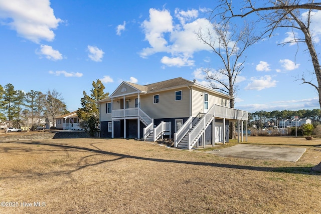 back of property featuring a yard