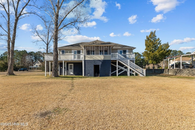 back of house featuring a wooden deck and a lawn