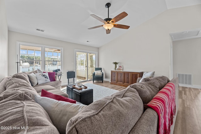 living room with hardwood / wood-style flooring, lofted ceiling, and ceiling fan