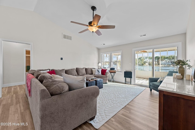 living room featuring ceiling fan, high vaulted ceiling, and light wood-type flooring