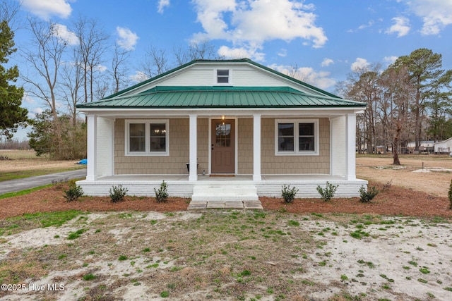 view of front facade with a porch and metal roof