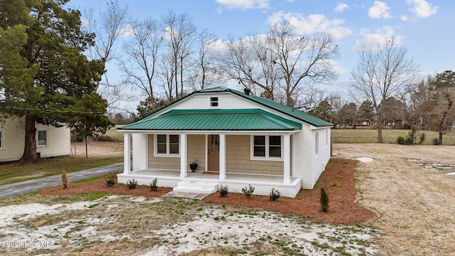 view of front of house with a porch and metal roof