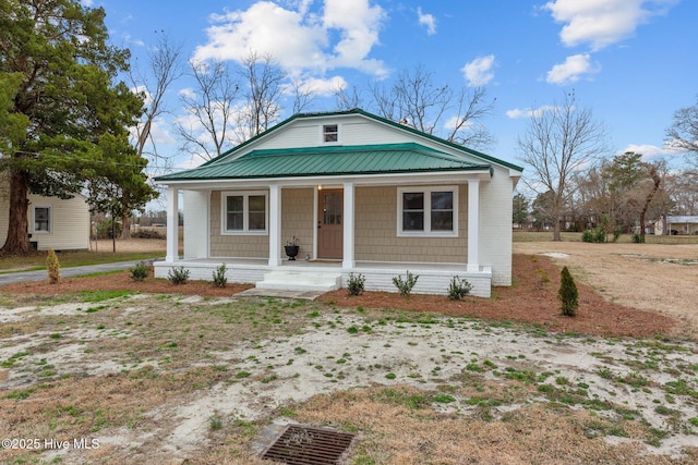 bungalow with covered porch and metal roof