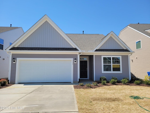 3709 W Cessna Way W Unit Ef 12, Wilson, NC 27896 - view of front of home featuring board and batten siding, driveway, a front lawn, an attached garage, and a shingled roof
