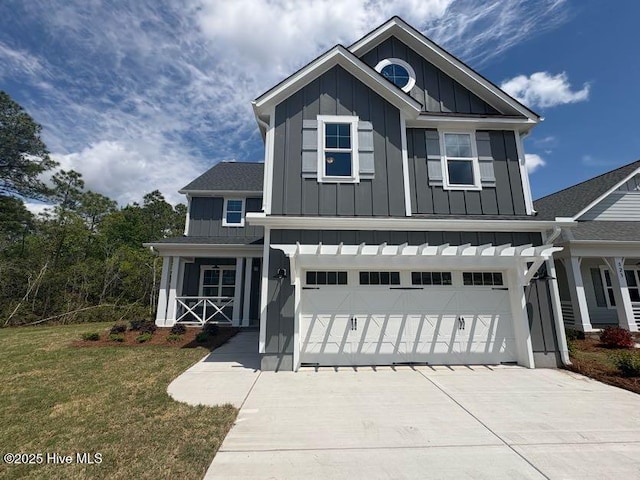 view of front of house with a porch, concrete driveway, a garage, a front lawn, and board and batten siding
