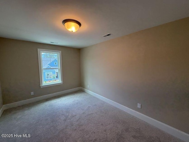 unfurnished room featuring light carpet, baseboards, and visible vents
