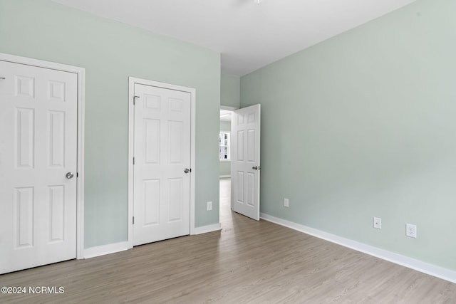 unfurnished bedroom featuring light wood-type flooring