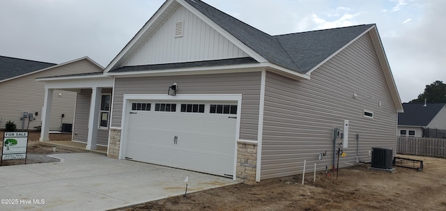 view of home's exterior featuring a garage and central air condition unit