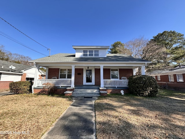 bungalow with a front lawn and a porch