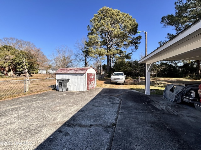 exterior space featuring an outdoor structure, fence, and a storage shed