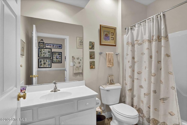 bathroom with toilet, vanity, and curtained shower