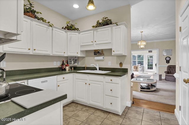 kitchen with sink, white cabinets, hanging light fixtures, and dishwasher