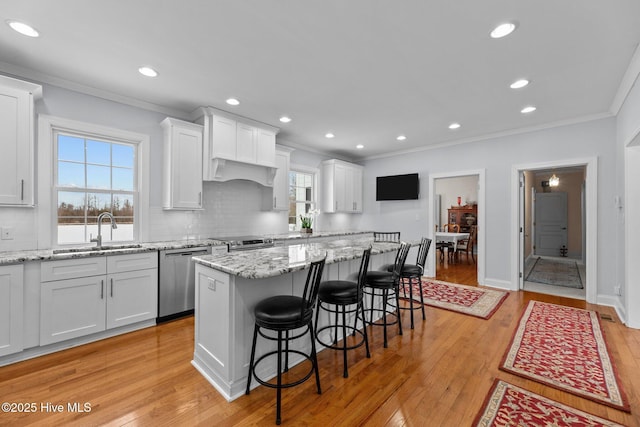 kitchen with stainless steel appliances, white cabinets, and a kitchen island