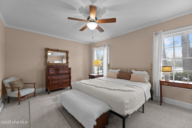 carpeted bedroom featuring ornamental molding and ceiling fan