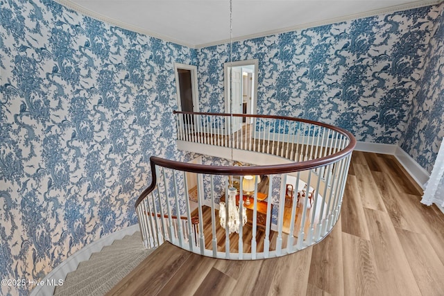 stairs featuring crown molding and wood-type flooring