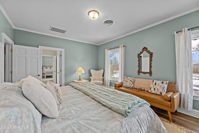 bedroom with crown molding and wood-type flooring