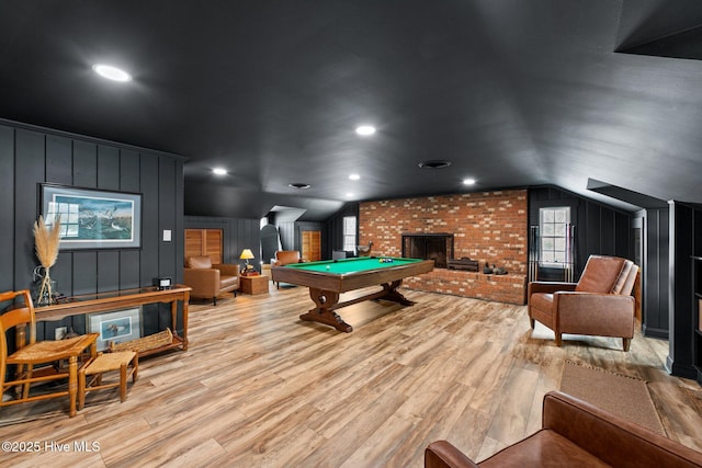 playroom with a fireplace, pool table, light hardwood / wood-style flooring, and vaulted ceiling