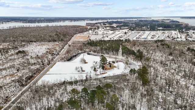 snowy aerial view featuring a water view