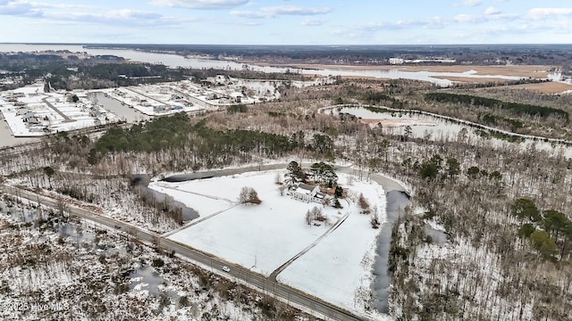 snowy aerial view featuring a water view