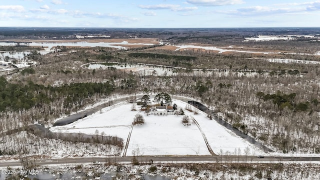 snowy aerial view featuring a water view