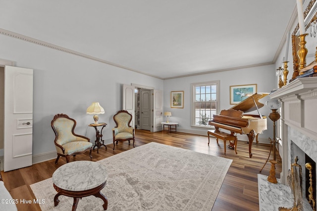 living area featuring dark hardwood / wood-style flooring, crown molding, and a high end fireplace