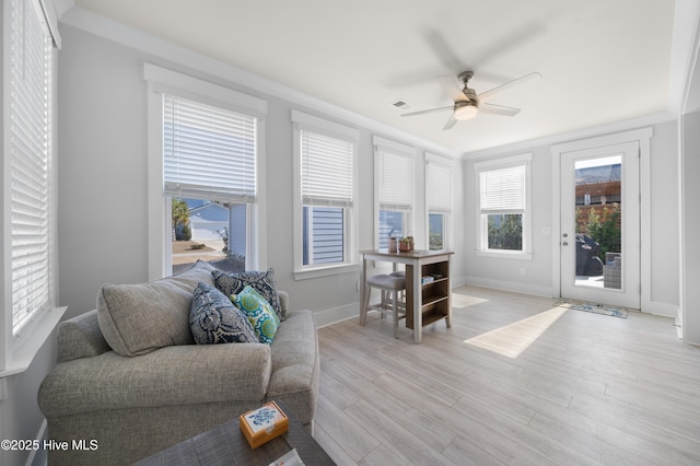 living room featuring light hardwood / wood-style flooring and ceiling fan