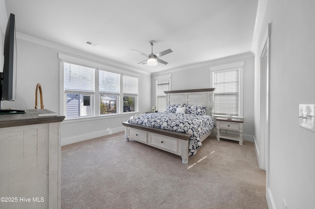 bedroom featuring multiple windows, crown molding, light colored carpet, and ceiling fan