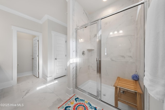 full bathroom with marble finish floor, a marble finish shower, baseboards, and ornamental molding