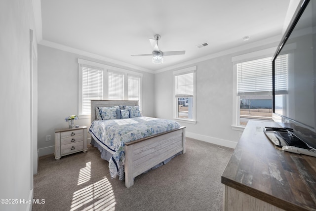 carpeted bedroom featuring ornamental molding, visible vents, ceiling fan, and baseboards