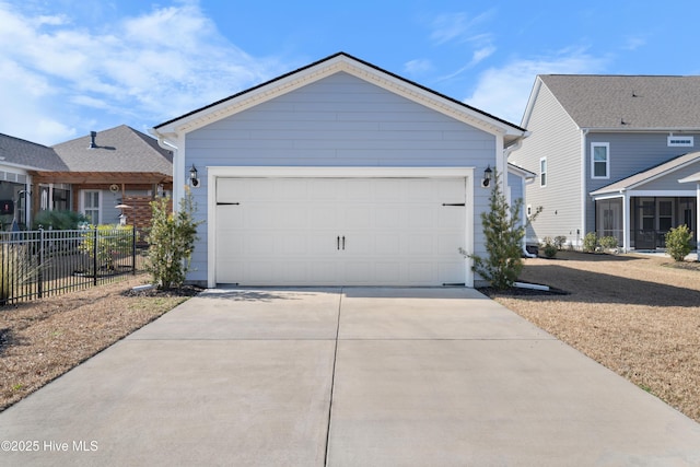 single story home featuring driveway, an attached garage, and fence