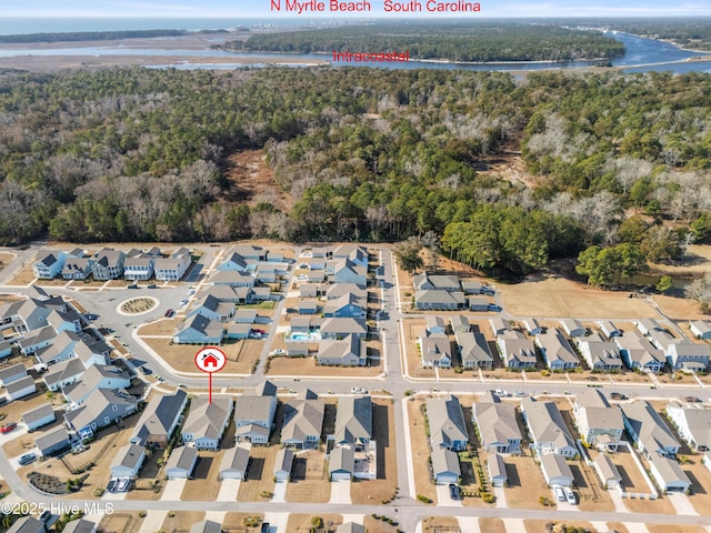 aerial view featuring a water view, a residential view, and a view of trees