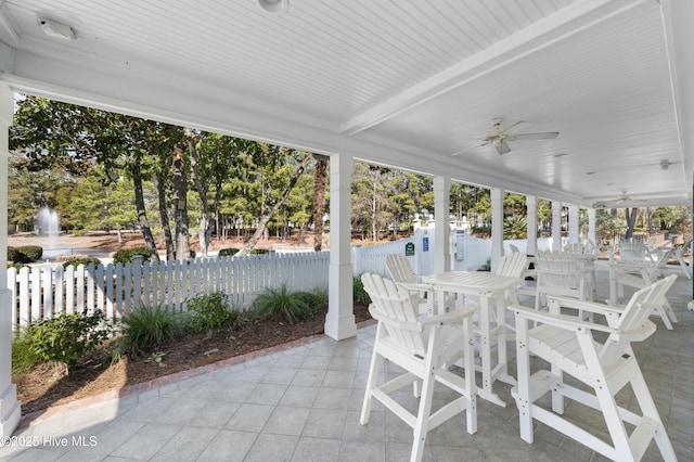 unfurnished sunroom featuring a ceiling fan