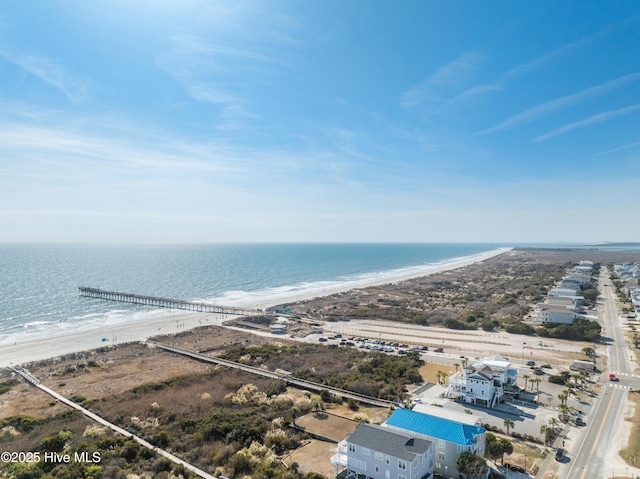 bird's eye view featuring a water view and a beach view