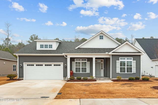 view of front of home featuring driveway, an attached garage, and roof with shingles