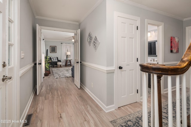 hall featuring ornamental molding and light wood-type flooring