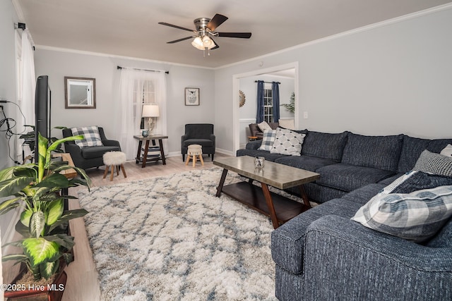 living room featuring hardwood / wood-style floors, ornamental molding, and ceiling fan