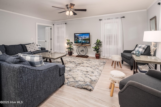 living room featuring crown molding, hardwood / wood-style floors, and ceiling fan