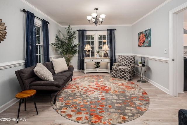 living area with ornamental molding, hardwood / wood-style floors, and a notable chandelier