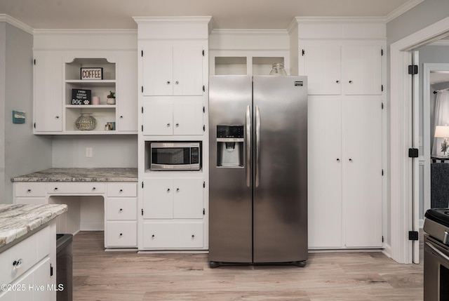 kitchen featuring crown molding, white cabinetry, light hardwood / wood-style flooring, appliances with stainless steel finishes, and light stone countertops