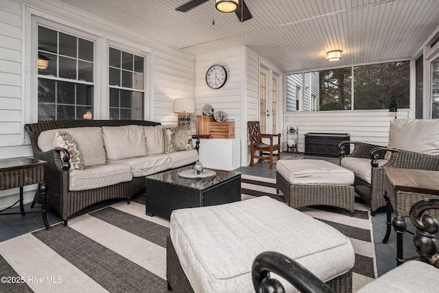 sunroom / solarium featuring wood ceiling and ceiling fan