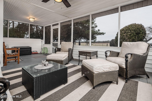 sunroom / solarium featuring ceiling fan