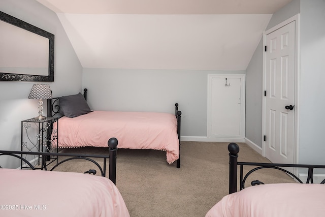 carpeted bedroom featuring lofted ceiling