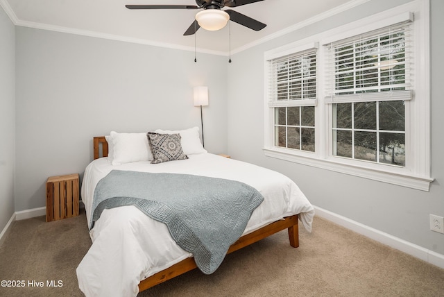 carpeted bedroom featuring crown molding and ceiling fan