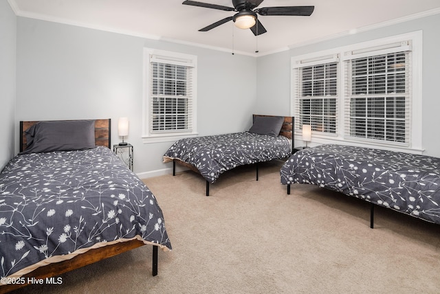 carpeted bedroom with ornamental molding and ceiling fan