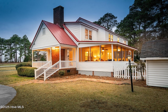 farmhouse-style home featuring a yard and covered porch