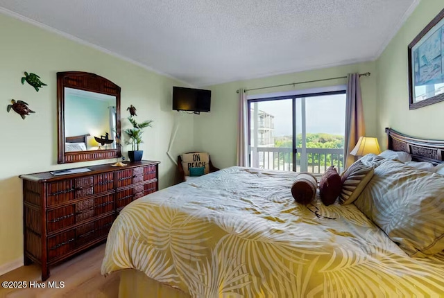 bedroom with access to exterior and a textured ceiling