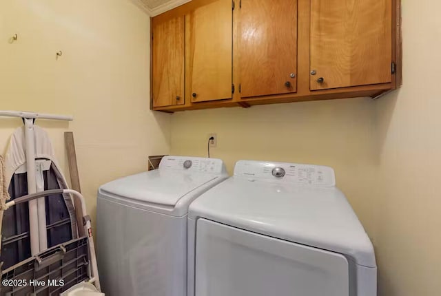 washroom with cabinets and independent washer and dryer