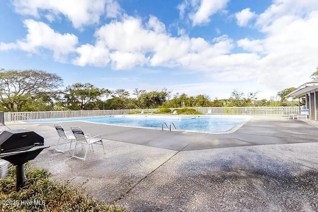 view of pool featuring a patio and grilling area